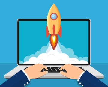 Man on computer and rocket on screen