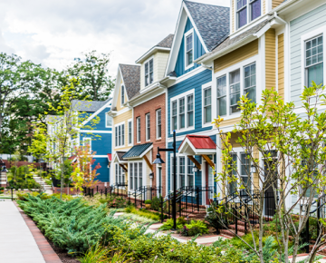 row of colorful townhomes and greenery