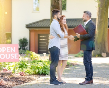 couple attending open house with agent