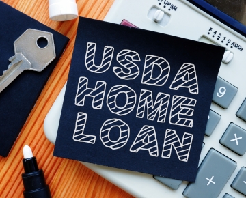 USDA Home Loan written out with key, calculator, and marker
