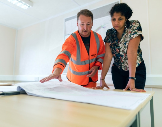 women looking at home plans with contractor